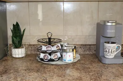 a counter top with coffee pots and a coffee maker at Home beside WEM in Edmonton