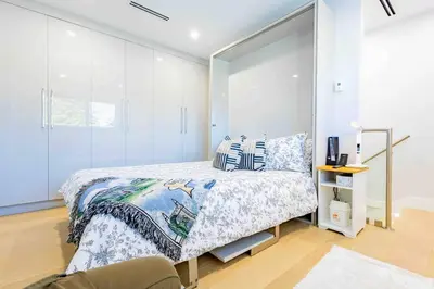 a bedroom with a bed and a glass wall at Charming & Brand-New near Restaurants & Transport in Vancouver