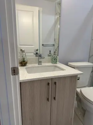 a bathroom with a sink and a toilet at Peaceful Haven in Prime Location in Calgary
