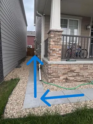 a house with a blue arrow on the front porch at Cozy Basement Suite, SW Calgary in Calgary