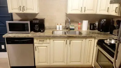 a kitchen with a sink and a microwave at Quiant 2 Bedroom Suite in Vancouver