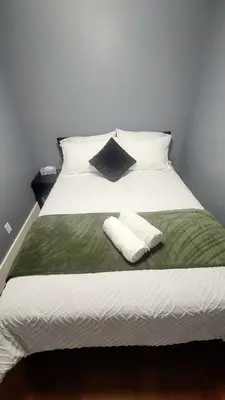 a large white bed with two pillows on it at Quiant 2 Bedroom Suite in Vancouver