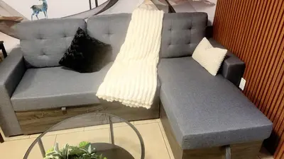 a gray couch with pillows on it in a room at Quiant 2 Bedroom Suite in Vancouver
