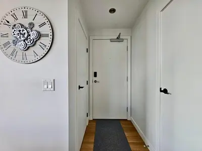 a large clock on a wall next to a door at Calgary&Downtown&BMO Centre & Parking in Calgary