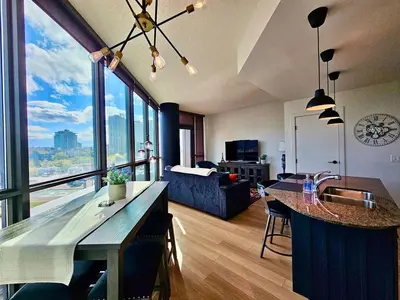 a kitchen and living room with a view of the city at Calgary&Downtown&BMO Centre & Parking in Calgary
