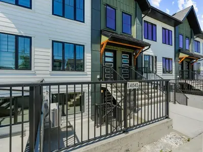 a house with a fence in front of it at Superb 1-Bdr Apt in New Condo in Calgary