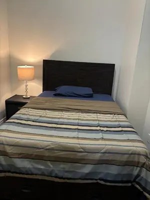 a bedroom with a bed and a lamp on a table at 3 Bed - Best View in Town! in Surrey