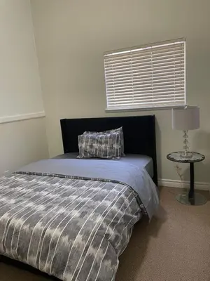 a bedroom with a bed with a pillow and a table at 3 Bed - Best View in Town! in Surrey