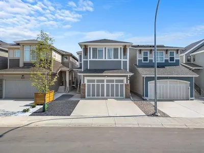 a row of houses in a residential neighborhood at Private Basement Magnolia Retreat Family Friendly Suite near Seton and Lake in Calgary