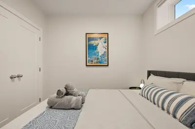 a bedroom with a bed with a stuffed animal on it at Cozy 2BR BSMT Suite with Board Games and Netflix in Calgary