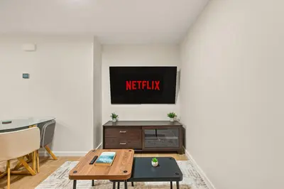 a living room with a television on a wall at Cozy 2BR BSMT Suite with Board Games and Netflix in Calgary