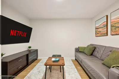 a living room with a couch and a table at Cozy 2BR BSMT Suite with Board Games and Netflix in Calgary