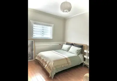 a bedroom with a bed and a window at Luxury New 5-bedroom 4- bathroom Single House in Surrey