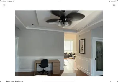 a living room with a ceiling fan and a chair at Luxury New 5-bedroom 4- bathroom Single House in Surrey