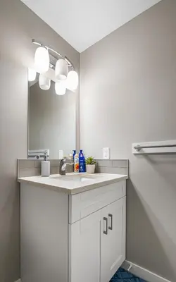 a bathroom with a sink and a mirror at Cozy & Large Furnished 2-Bedroom Suite in Calgary