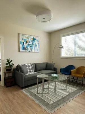 a living room with a couch and a table at Oceana Retreat Cozy 1BR with Outdoor Oasis in Victoria