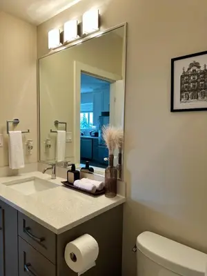 a bathroom with a sink and a mirror at Oceana Retreat Cozy 1BR with Outdoor Oasis in Victoria