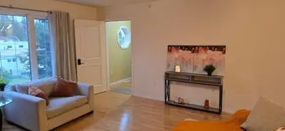 a living room with a couch and a fireplace at Northern Manor in Yellowknife