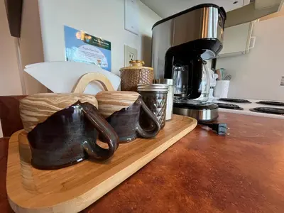 a kitchen counter with a coffee maker and a wooden cutting board at Lake View Suite, Forest Retreat, Balfour BC in Balfour