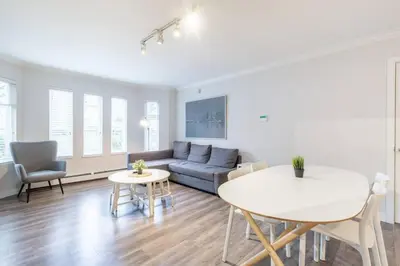 a living room with a couch and a table at Sleek Modern Escape Suite - Comfort and Style in the City in Vancouver