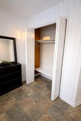 a walk in closet with a mirror and a dresser at Great Northern Escapes - The Managers House in Yellowknife