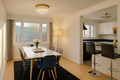 a dining room and kitchen with a table and chairs at Great Northern Escapes - The Managers House in Yellowknife