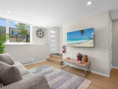 a living room with a couch and a table at Exquisite 1-Bdr Condo Apt in Calgary