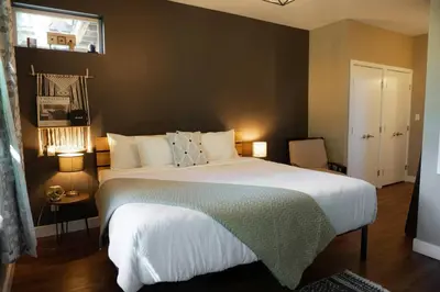 a bedroom with a large bed and a window at The Inlet Haven - 2 Bedroom on the Inlet in Ucluelet