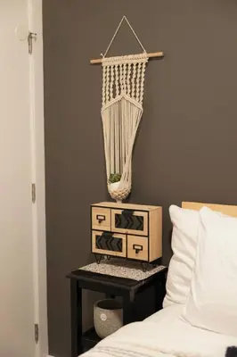 a bedroom with a bed and a net on a wall at The Inlet Haven - 2 Bedroom on the Inlet in Ucluelet
