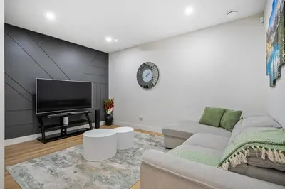 a living room with a couch and a flat screen tv at Private Sherwood Suite by Park in Calgary