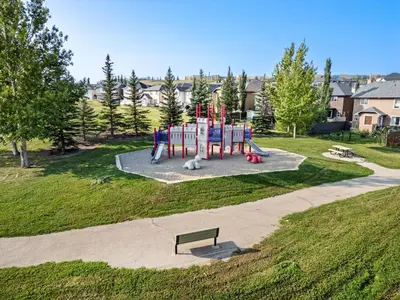 a playground in a park with a bench at Private Sherwood Suite by Park in Calgary