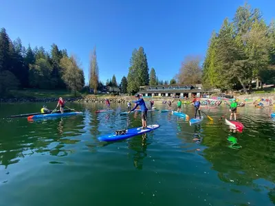 a group of people on paddle boards in the water at Casa del Mar Villa in North Vancouver