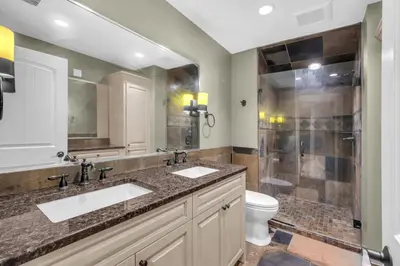 a bathroom with two sinks and a shower at Rocky View Bed & Breakfast in Calgary