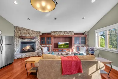 a living room with a couch and a fireplace at Rocky View Bed & Breakfast in Calgary