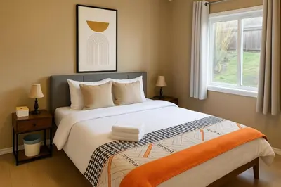 a bedroom with a large bed and a window at Cozy and Relaxing Private Getaway Free Parking in Nanaimo
