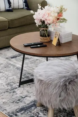 a coffee table with a vase of flowers on it at Cozy and Relaxing Private Getaway Free Parking in Nanaimo