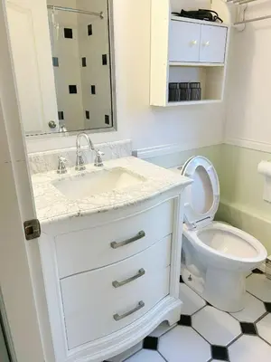 a white bathroom with a sink and a toilet at Cozy and Relaxing Private Getaway Free Parking in Nanaimo
