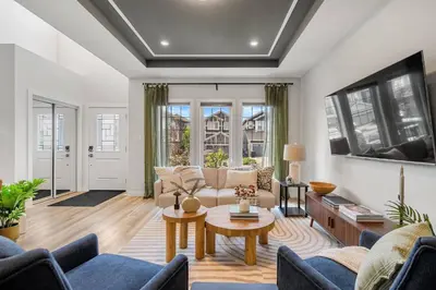 a living room with a couch and a table at NEW Restful Retreat with Hot Tub, King Bed, AC, Garage, Near WEM in Edmonton