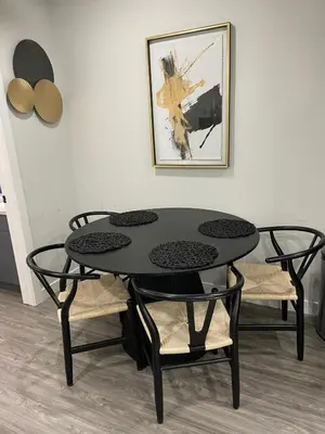 a black table and chairs in a room at The Willow Nest lower suite-2 Rooms in Calgary