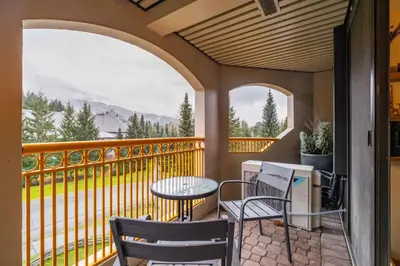 a balcony with a table and chairs and a view at Marquise 610 by Outpost Whistler in Whistler