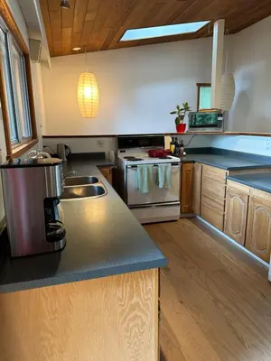 a kitchen with a sink and a counter top at Ocean Vista In the Woods on Saltspring Island in Salt Spring Island