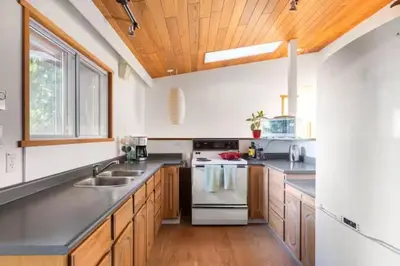 a kitchen with a sink and a stove top oven at Ocean Vista In the Woods on Saltspring Island in Salt Spring Island