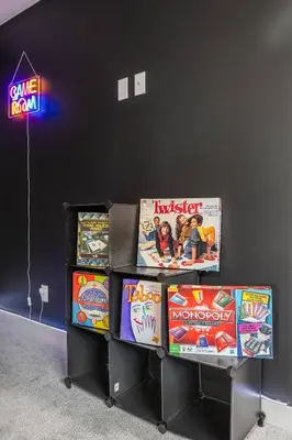 a table with some games and a neon sign at Cowboy Chalet SE|AC|Games|King Bed|20 min to DT in Calgary
