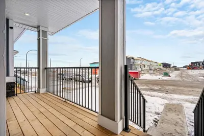 a balcony with a view of a construction site at Cowboy Chalet SE|AC|Games|King Bed|20 min to DT in Calgary