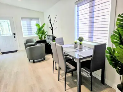 a dining room with a table and chairs at The Oasis in Stettler! in Stettler