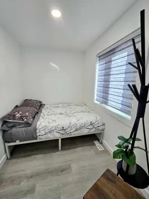 a bedroom with a bed and a window at The Oasis in Stettler! in Stettler