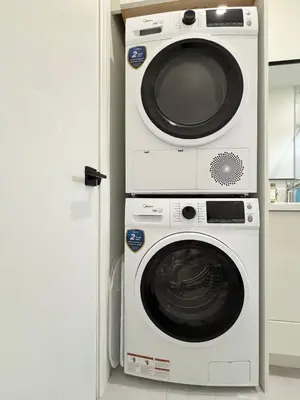 two washing machines stacked on top of each other in a kitchen at South surrey Secondary Suite with Kitchen in Surrey