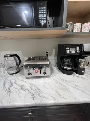 a kitchen counter with a stove and a microwave at Beautiful Entire 2 Bedroom Suite in Nanaimo