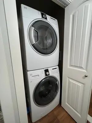 a washer and dryer in a room next to a door at Beautiful Entire 2 Bedroom Suite in Nanaimo