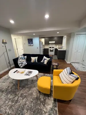 a living room with a couch and a table and chairs at Beautiful Entire 2 Bedroom Suite in Nanaimo